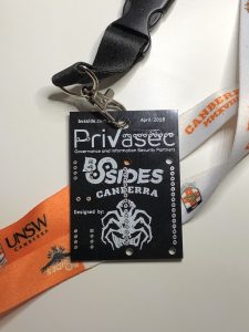Black BSides CBR electronic badge without components with orange and white lanyard
