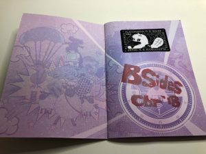 Open purple passport with BSides CBR stamp and platypus camp 2017 stamp