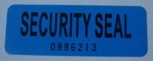 Blue non-transfer tamper evident label with black text and serial number