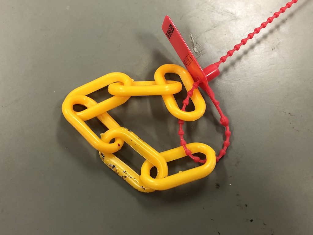 Yellow plastic chain sealed with a red B-Sealed LightLock tamper evident seal