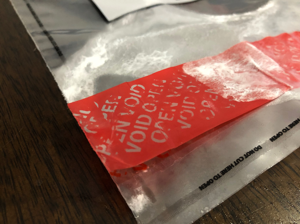 Tamper evident bypassing a tamper evident bag showing void as the bag has been opened