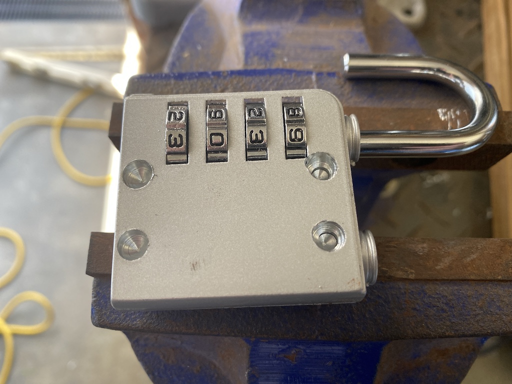combination padlock with rivets drilled out