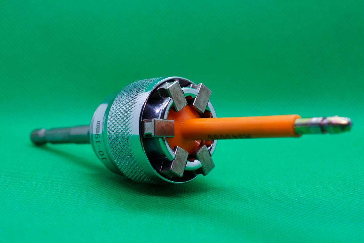 Custom bolt seal bypass tool showing tool with orange bolt seal in it after spinning off