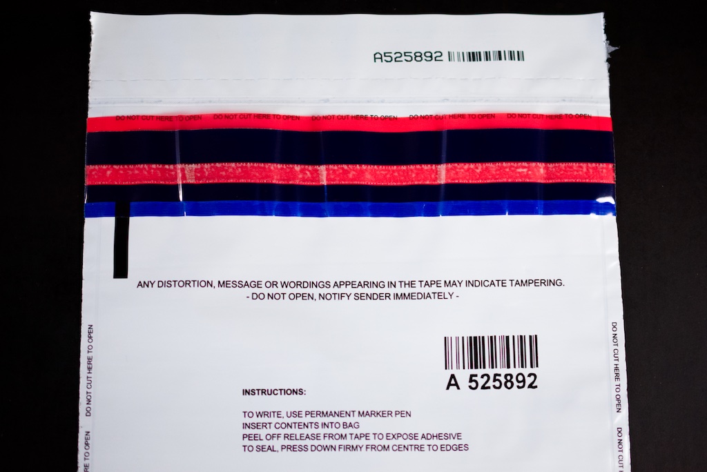 Tamper evident bag showing tamper evident strip, serial numbers and barcodes
